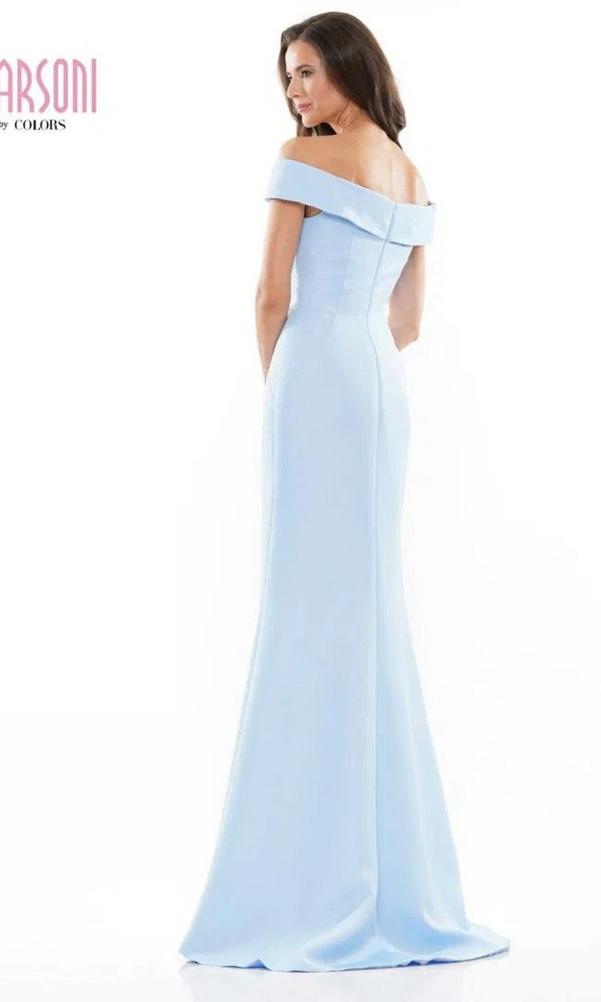A woman stands slightly turned on a white background wearing the Long Formal Dress: Marsoni MV1003—a light blue, off-the-shoulder satin evening gown with subtle beaded floral embellishments.